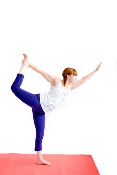 middle aged redhead woman exercising yoga isolated on white