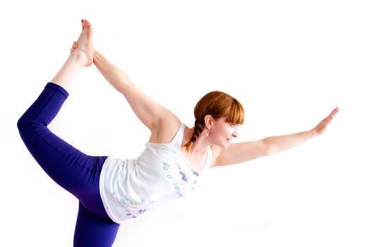 middle aged redhead woman exercising yoga isolated on white