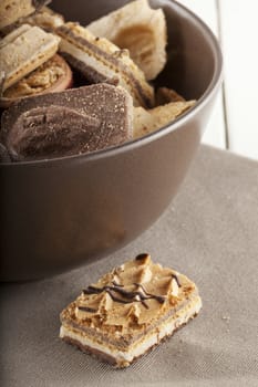 Assorted biscuits of different kind in a brown cup