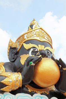 Rahu (god of darkness) statue with blue sky