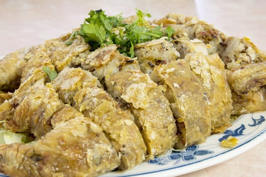 Glutinous Rice Deep Fried Stuffed Whole Chicken Chinese Dish Garnished with Cilantro Closeup