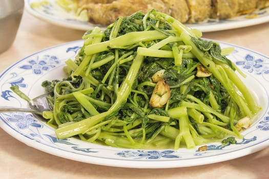 Stir Fry Chinese Kangkong Green Vegetable with Garlic Dish Closeup