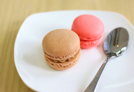 Tasty sweet macaron with spoon