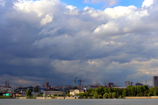 Cityscape before thunderstorm with dramatic and contrasts clouds. This is Novosibirsk in Russia.