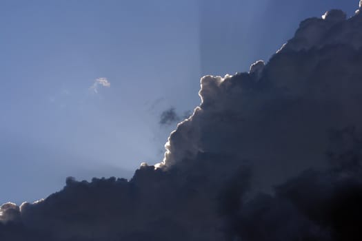 Cloud and sunlight contrasts sunbeam and dark clouds