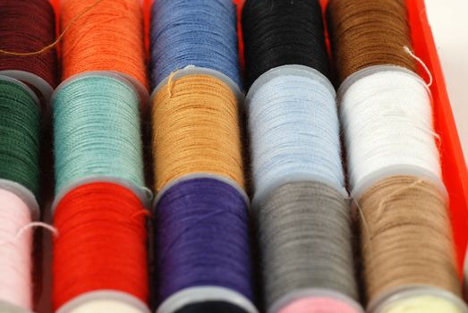 colorful spools of multi colored threads for sewing and knitting