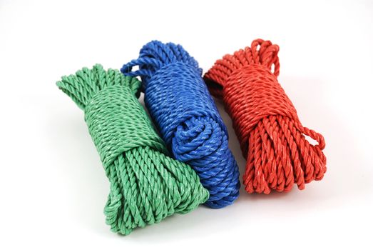 three coils of rope in green, blue and red