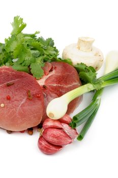 Perfect Boneless Raw Pork with Parsley, Spring Onion, Red Garlic, Edible Mushrooms and Spices isolated on white background