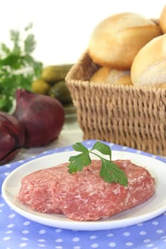 raw minced meat and parsley on a white plate