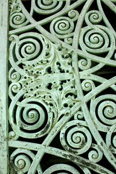 Close up of a panel on metal doors aged and weathered to a green patina, on a mausoleum at Graceland Cemetery, Chicago, Illinois, USA