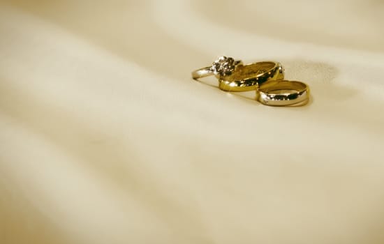 Gold wedding rings with engagement ring inside box 