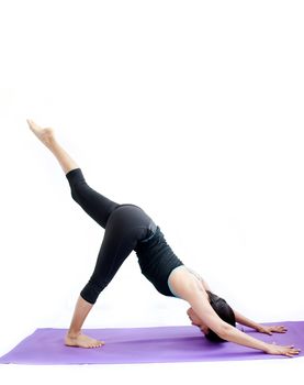 young brunette girl practising yoga isolated on white