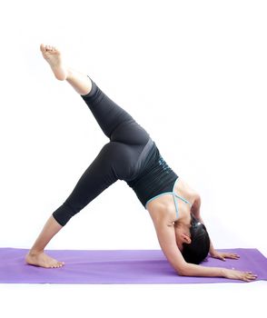 young brunette girl practising yoga isolated on white