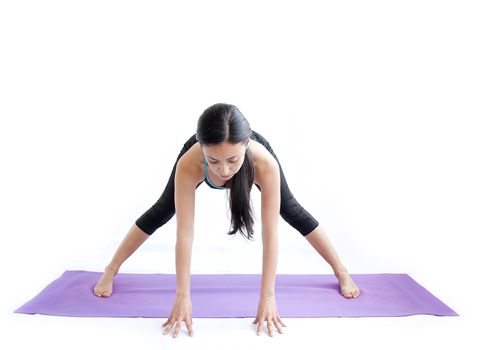 young brunette girl practising yoga isolated on white