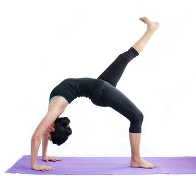 young brunette girl practising yoga isolated on white