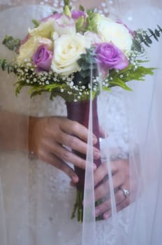 Close-up of wedding bouquet made of white and pink roses