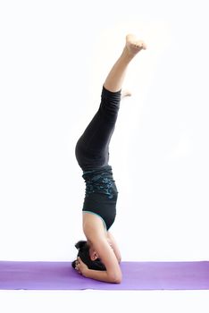 young brunette girl practising yoga isolated on white