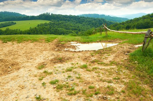 Wooden fence on pasture in the mountains