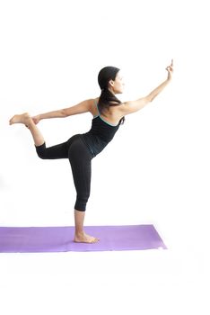 young brunette girl practising yoga isolated on white