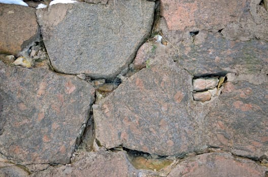 ancient grunge polished stone wall background closeup fragment.