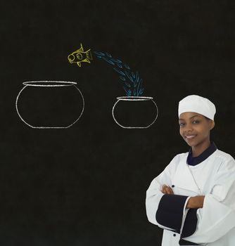 Woman female African or African American chef jumping fish decision on chalk blackboard background