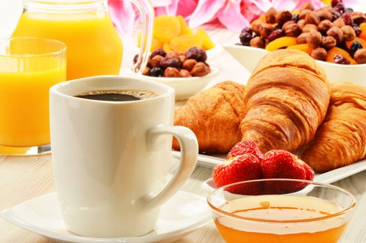 Breakfast with croissants, cup of coffee and fruits