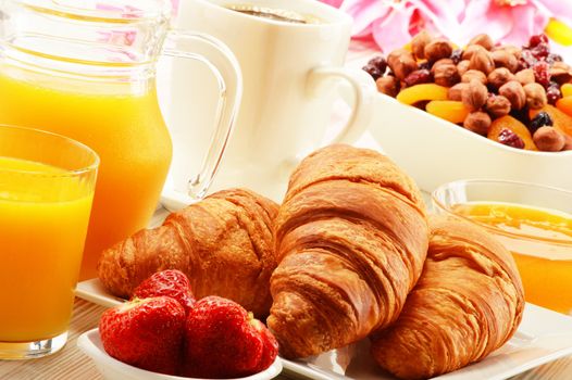 Breakfast with croissants, cup of coffee and fruits