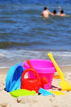 Plastic children toys on the sand beach