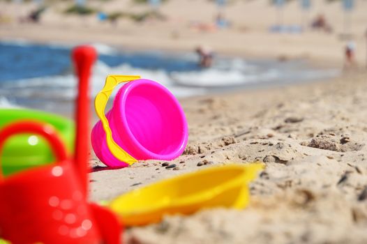 Plastic children toys on the sand beach