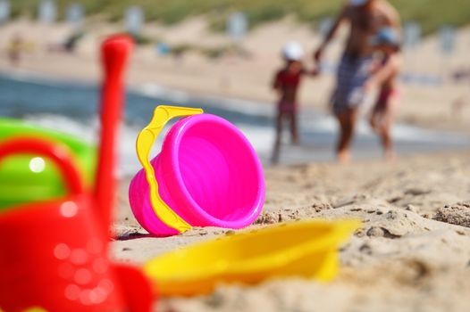 Plastic children toys on the sand beach