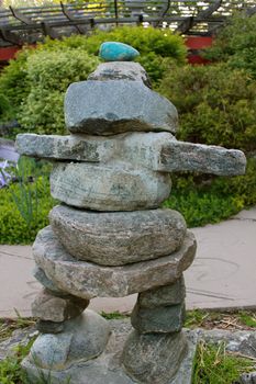 An inuksuk (or cairn) in a park, marking a trail.