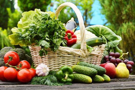 Fresh organic vegetables in wicker basket in the garden