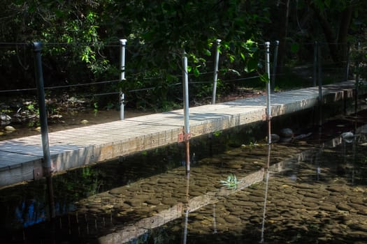 Old Wood Bridge Over Peaceful Stream