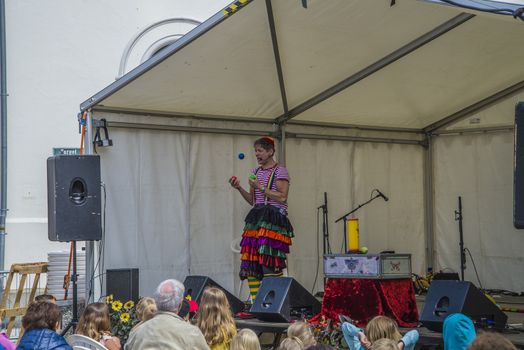 A skilled clown who entertains the kids with juggling, magic tricks and high jinks on Halden squares, Norway.