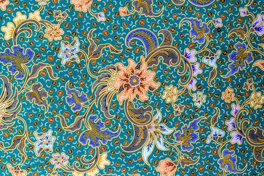 Orange flower pattern on blue fabric background