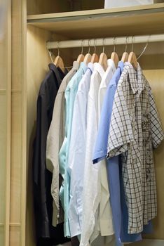 Man clothes hanging in closet 