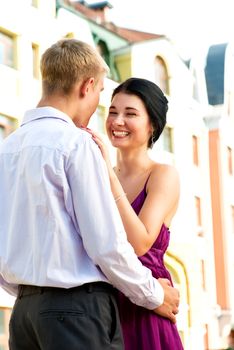 Young attractive couple loughing on street
