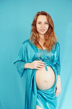 Pregnant woman on a turquoise background