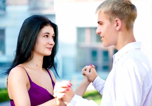 Young attractive smiling couple on street