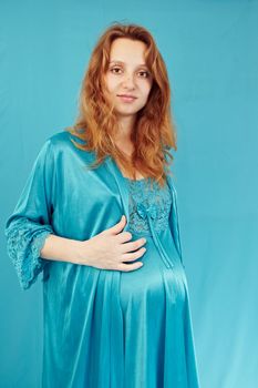 Pregnant woman on a turquoise background