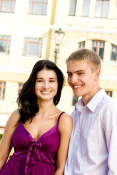 Young attractive smiling couple on street