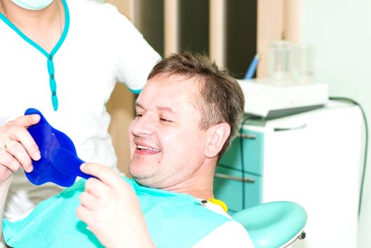 Portrait of men after cleaning teeth procedure. Happy and smiling