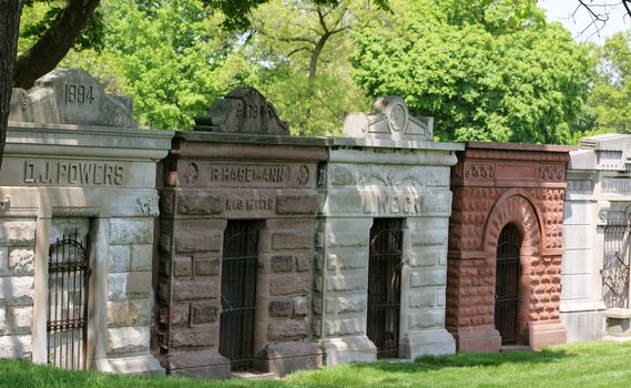 A row of well maintained, century old, stone mausoleums in Graceland Cemetery, Chicago, Illinois, USA