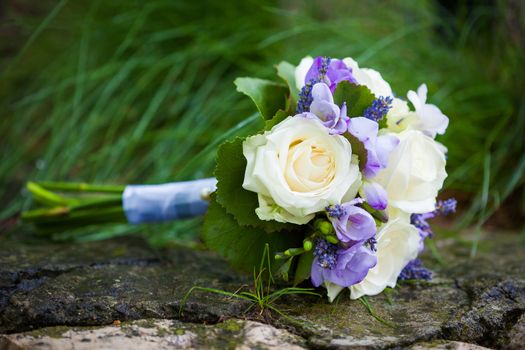 Wedding bouquet with yellow roses and lavender flowers