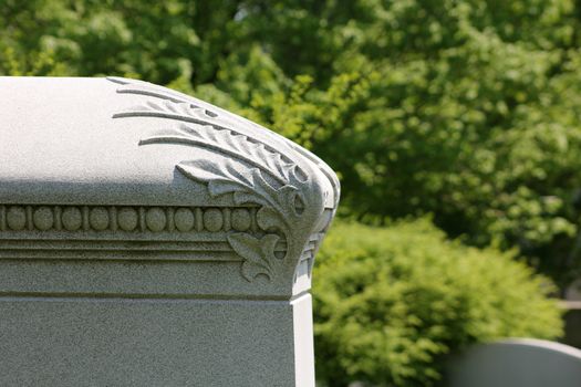 Closeup of a corner of a simply decorated, stone sarcophagus, at Graceland Cemetery, Chicago, Illinois, USA