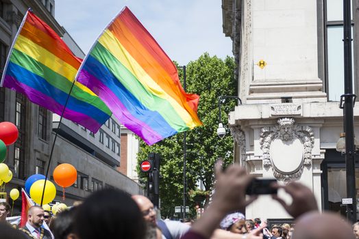 LONDON, UK - JUNE 29: Rainbow flags in front of department store Selfridges at the London Gay Pride parade in Oxford Street. June 29, 2013 in London.