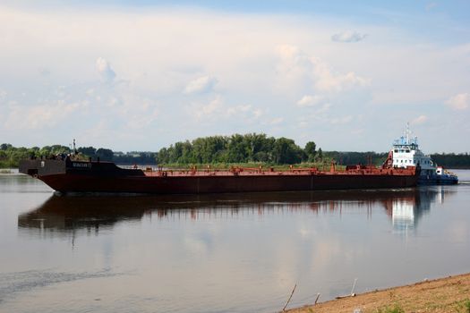 floating on the river barge on the background of blue sky