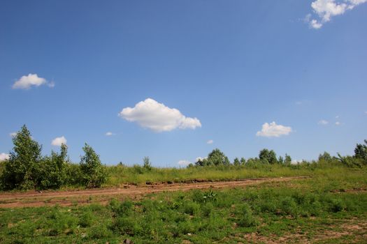 landscape with green meadows, sky and clouds