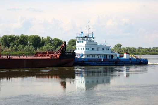 barge floating down the river in a forest and sky