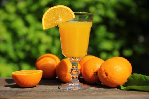 Still life with oranges and juice in a glass